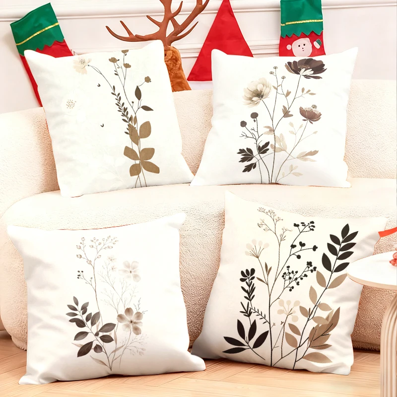 Elegant-botanical-throw-pillows-adorn-cozy-sofa-with-festive-holiday-stockings-and-reindeer-antlers-in-background